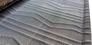 Close-up of gray woven fabric with a repeating textured pattern