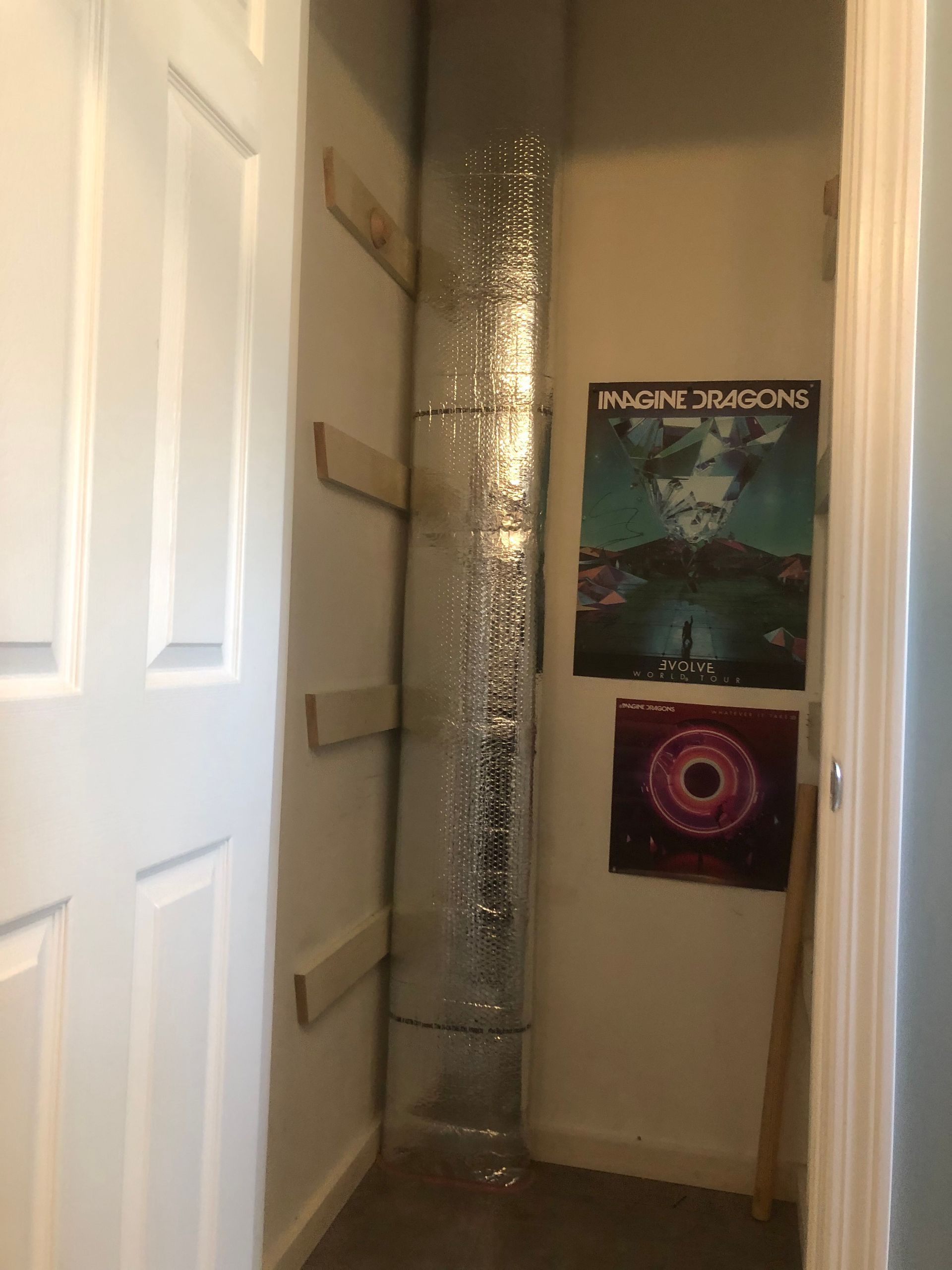 A room with a poster on the wall that says panic at the disco