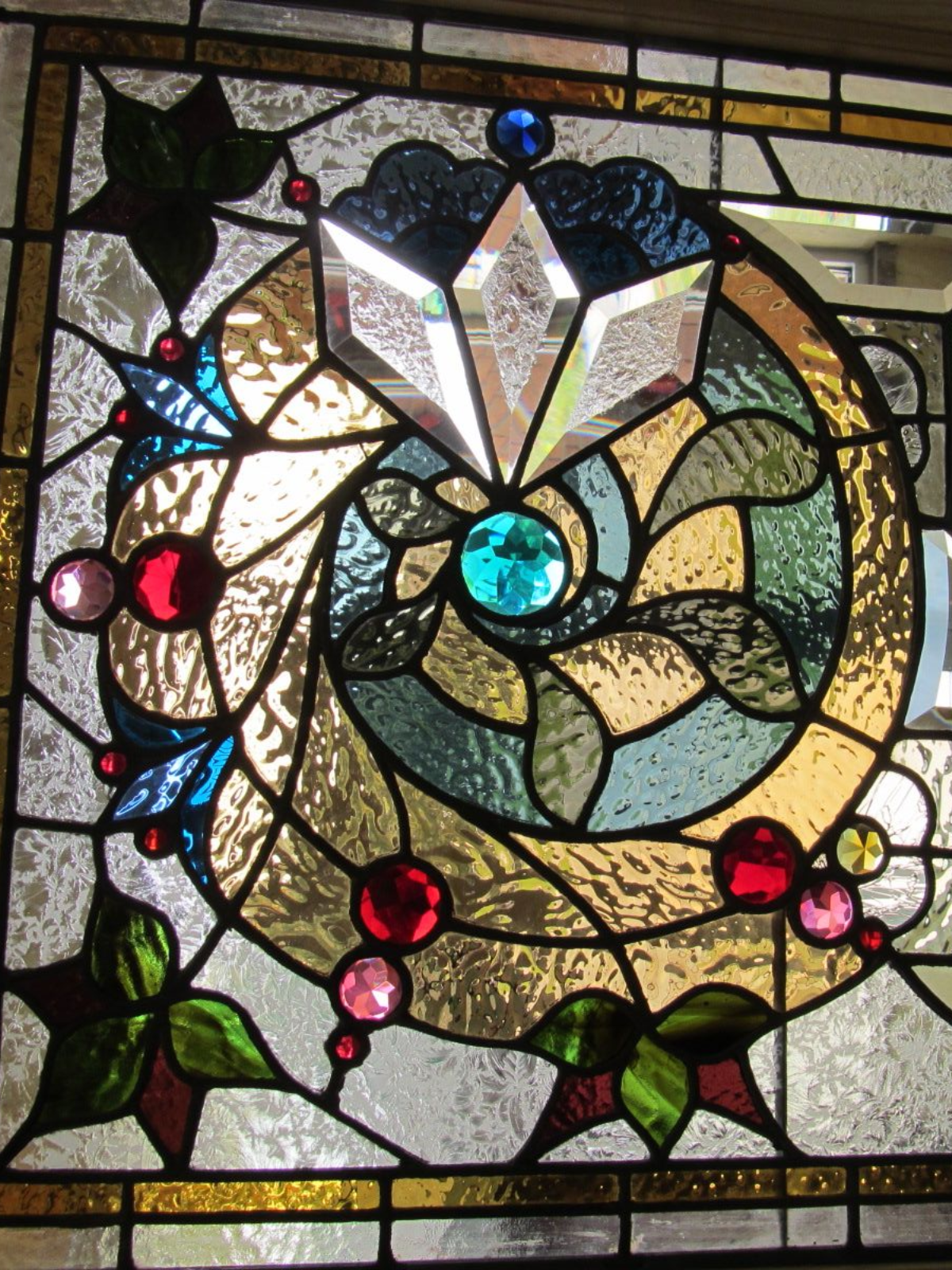 A stained glass window with a spiral design on it