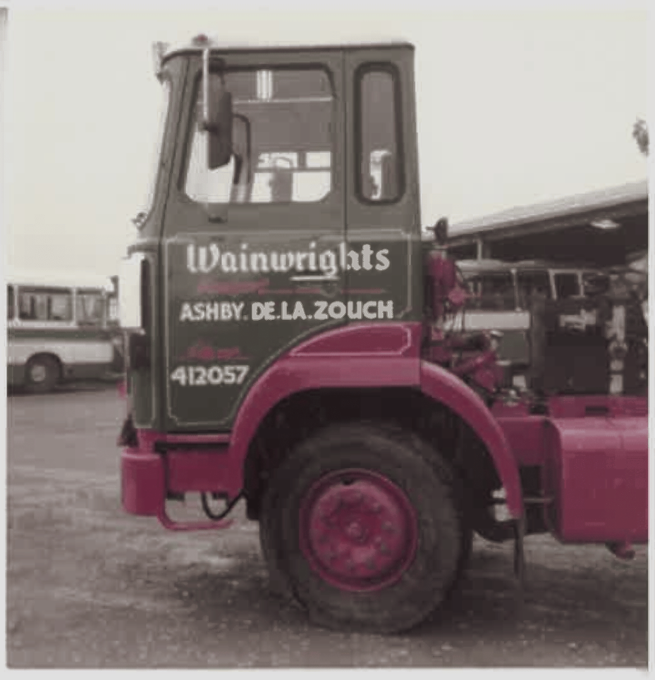 Green and red Wainwrights truck, Ashby de la Zouch, parked outside.