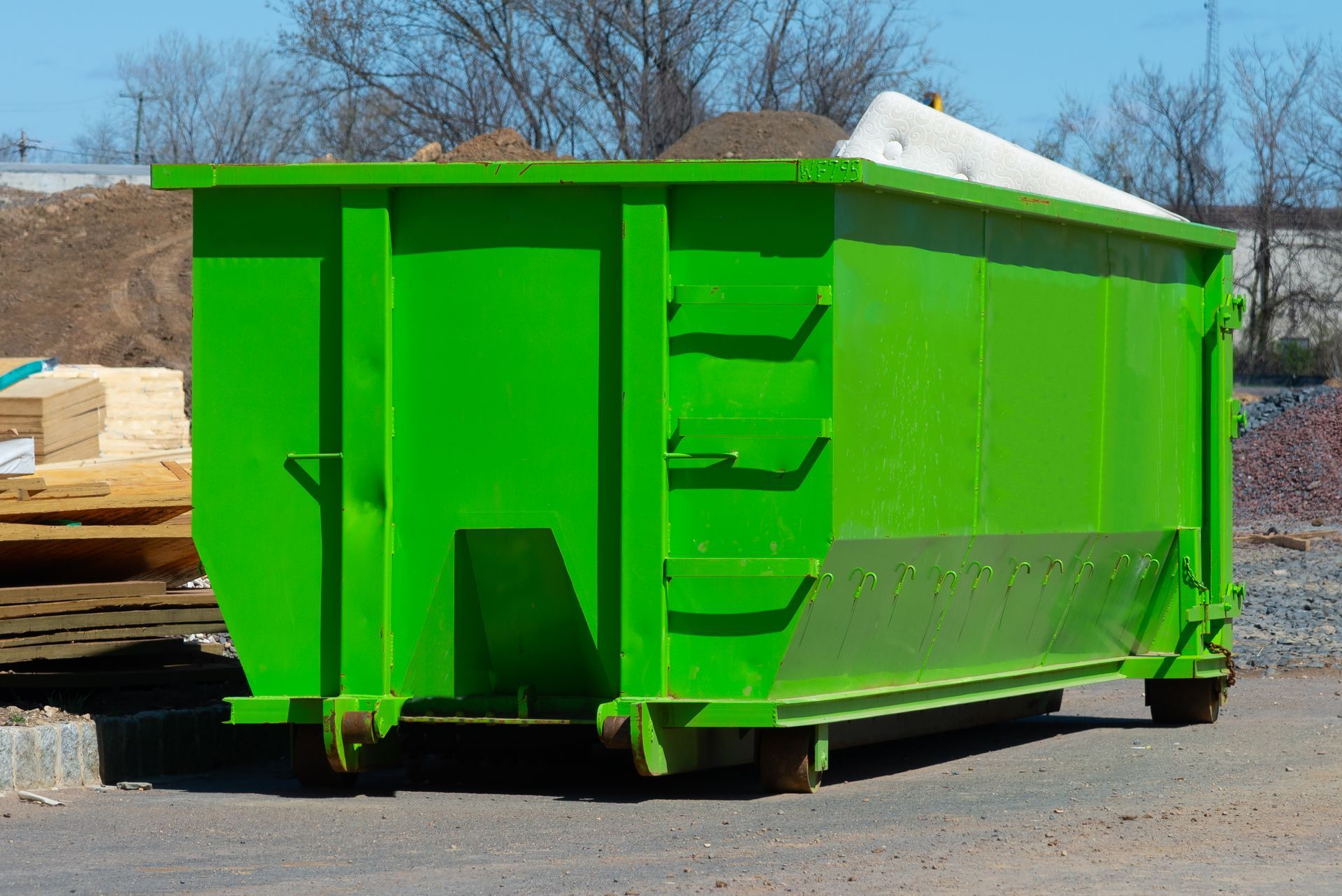 Green dumpster on wheels