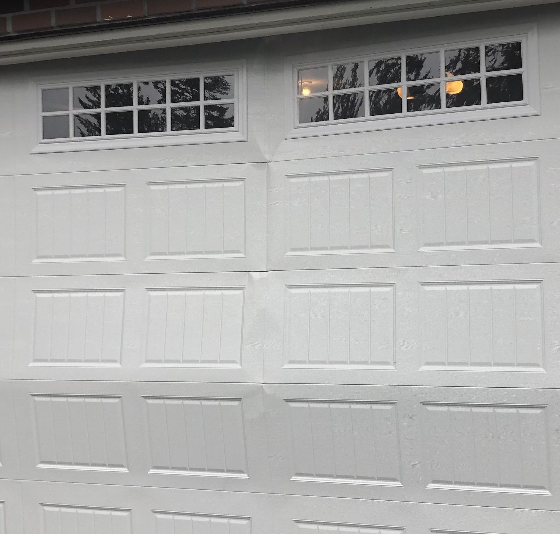 Damaged residential garage door needing service and repair by Garage Tech serving Woodinville Washington