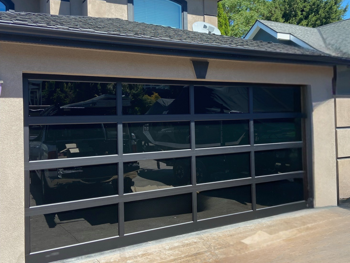 Modern glass garage door with black aluminum frame in Bothell