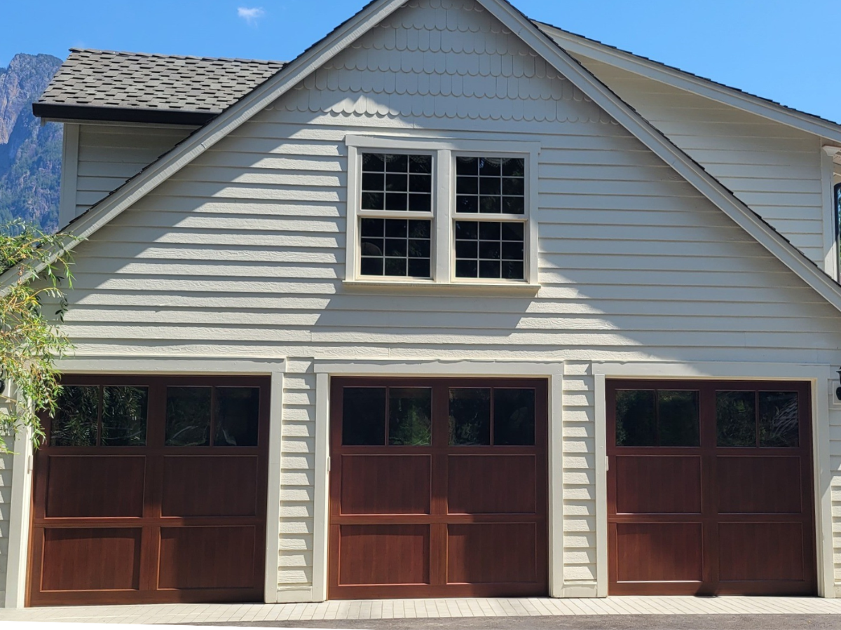 Wood-look carriage house garage doors on a custom two-story home