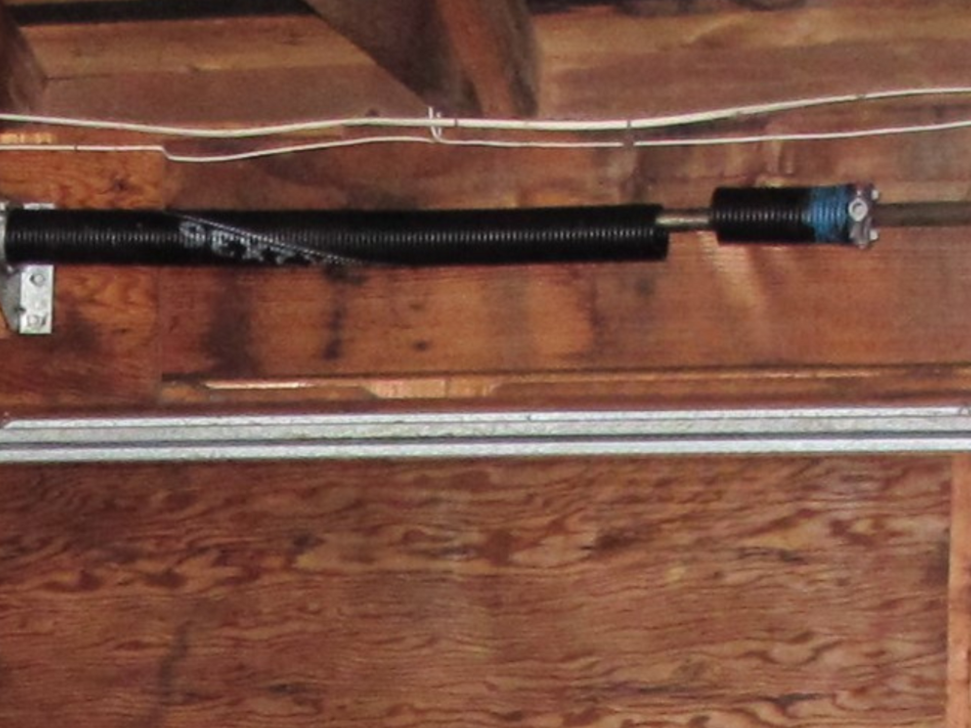 Broken torsion spring on residential garage door serviced by Garage Tech