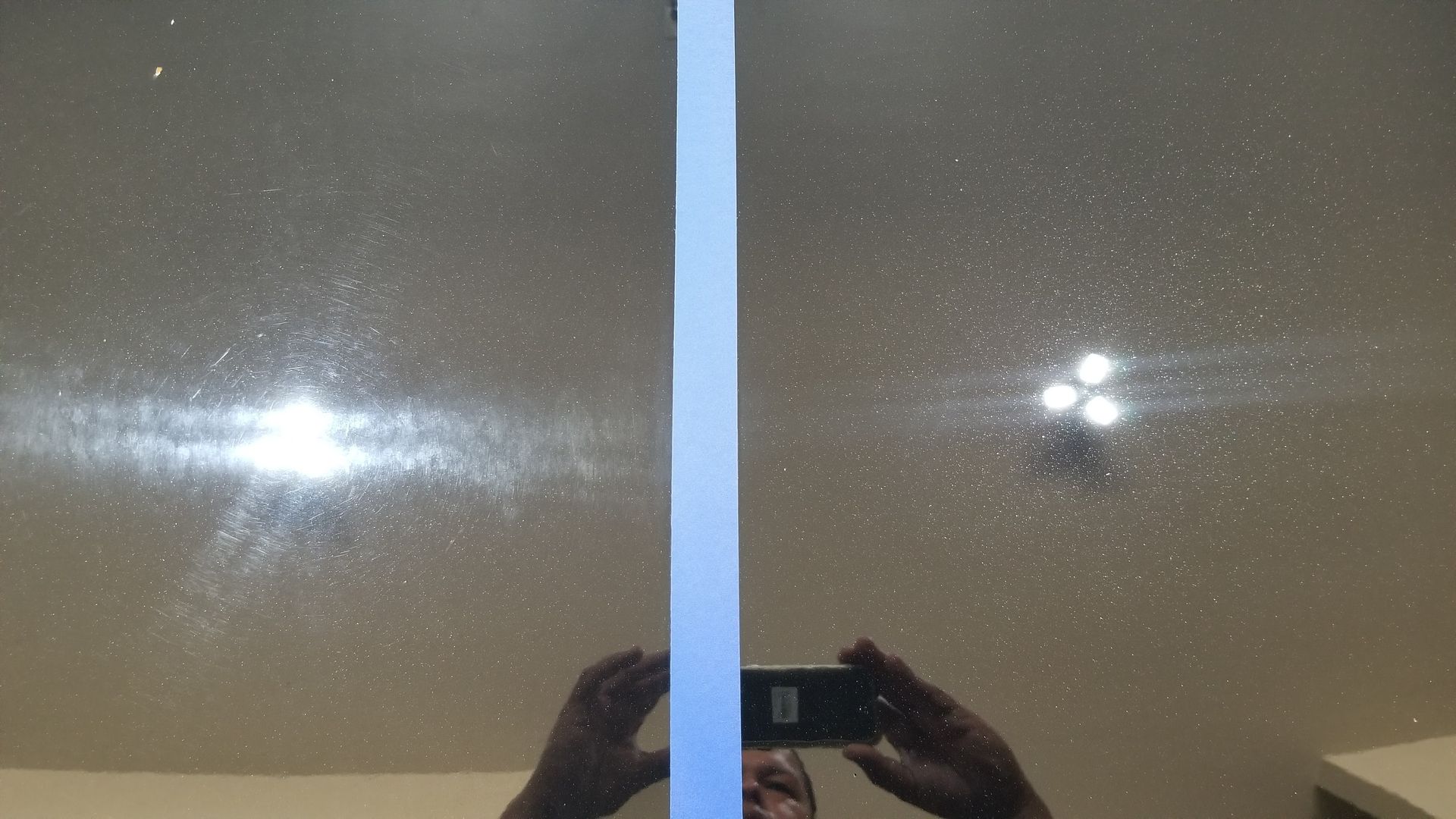 A person is taking a picture of themselves in a mirror.