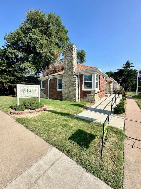 Brick building with sign for Elm & Co. Therapy. Ramp for accessibility.