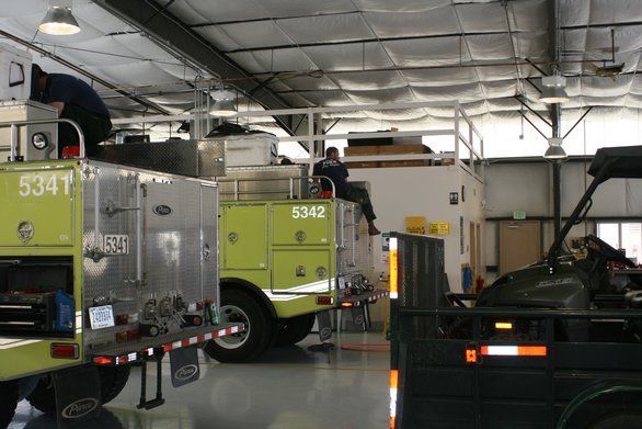 fire trucks waiting for tank repair service