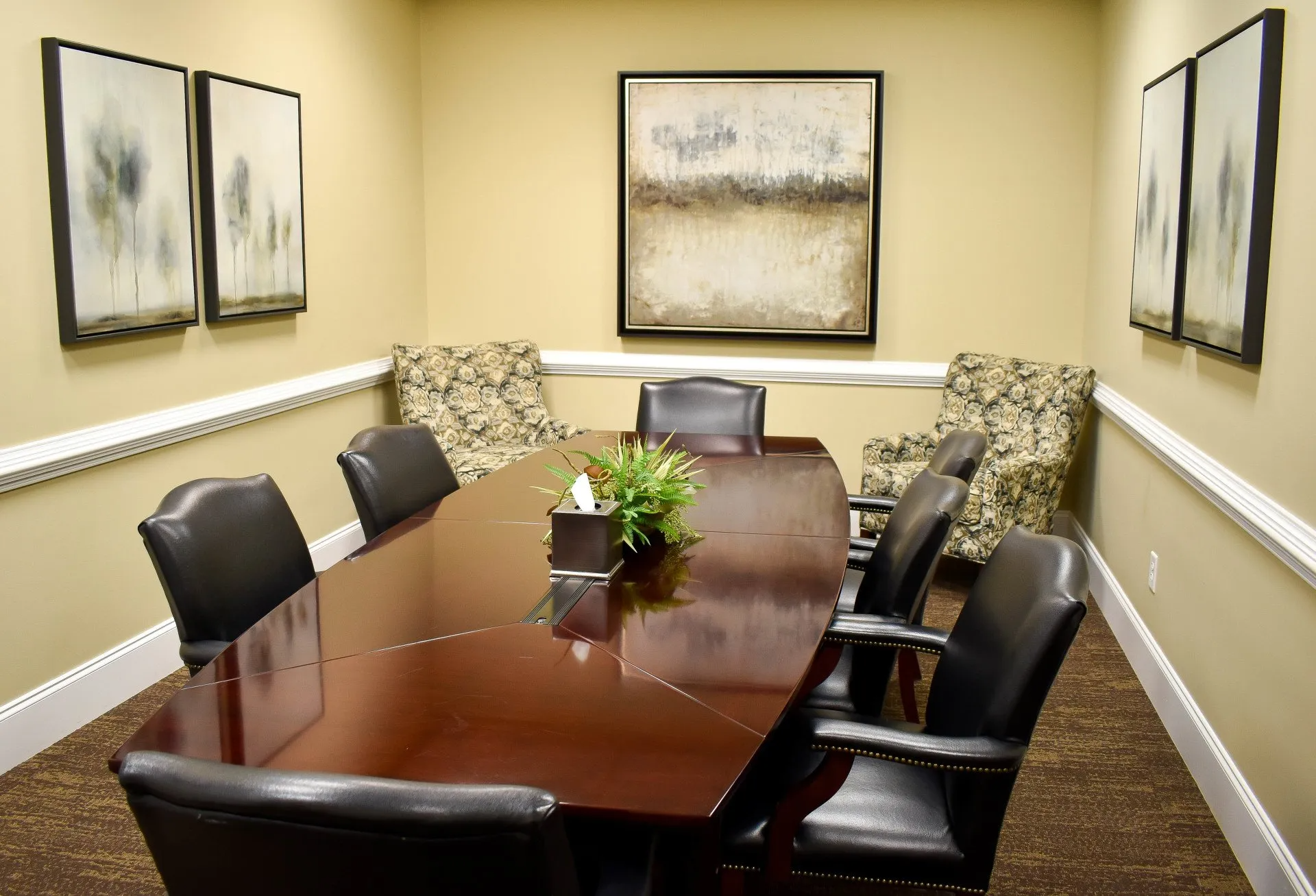 A conference room with a long table and chairs