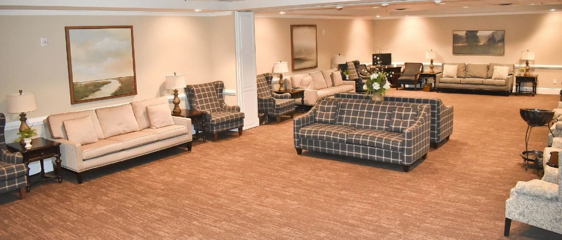 A living room filled with furniture and a painting on the wall.