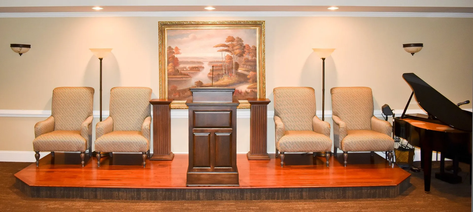 A podium in a room with chairs and a piano