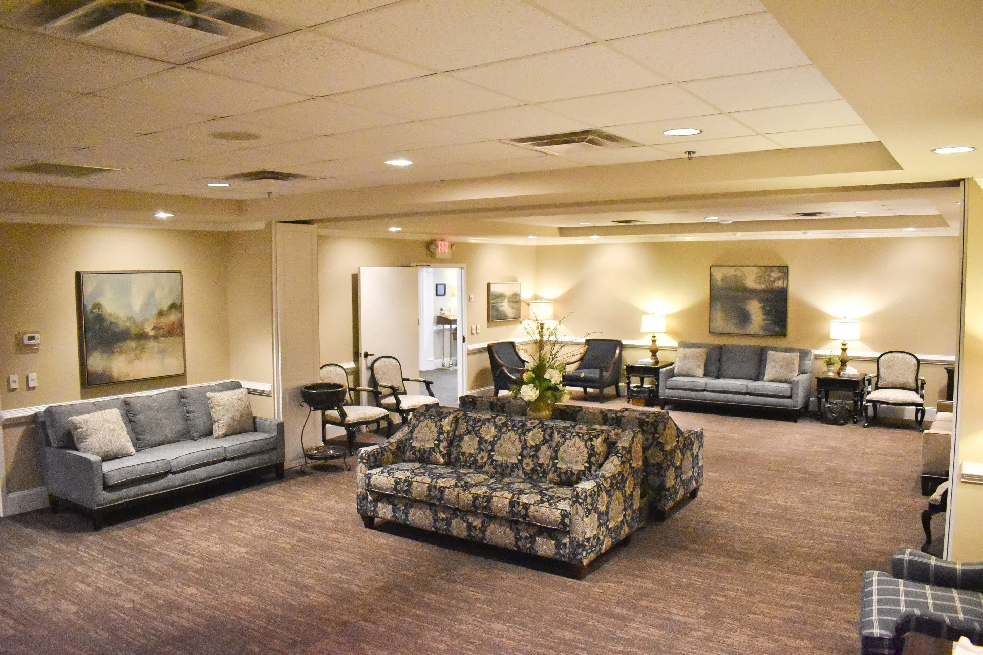 A living room with a lot of couches and chairs