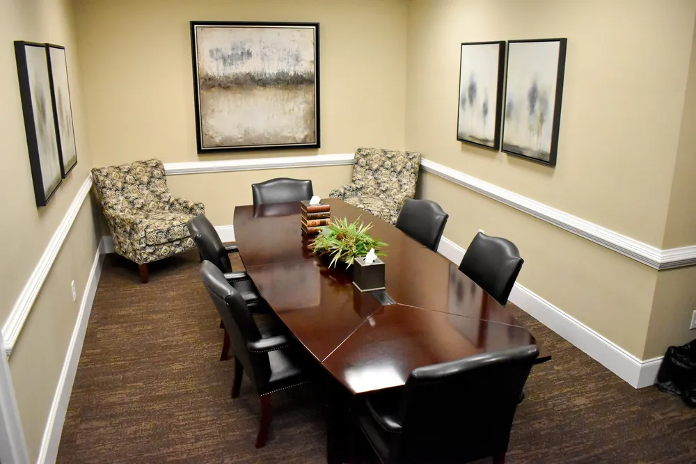 A conference room with a long table and chairs