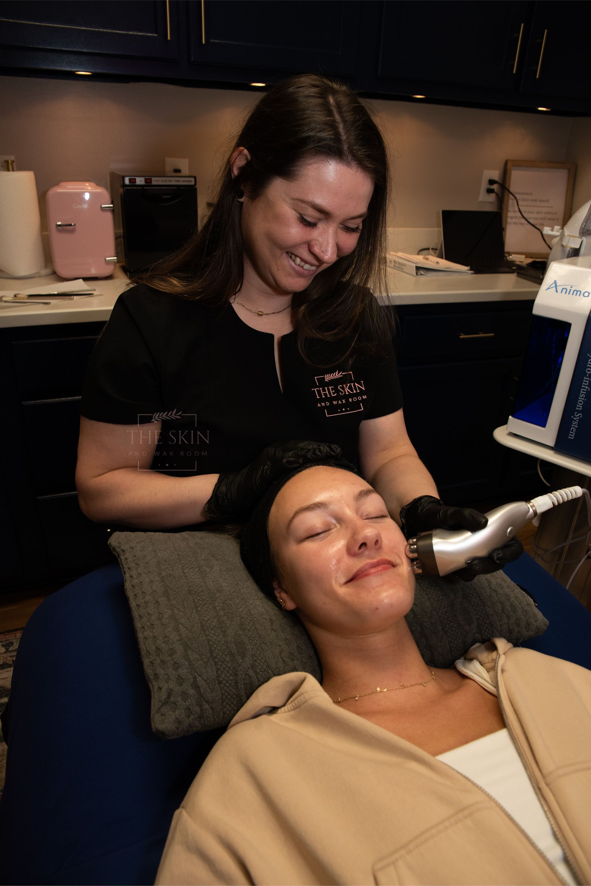 A woman is getting a facial treatment at a beauty salon.