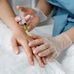 Medical robotic device over a patient’s abdomen during a procedure