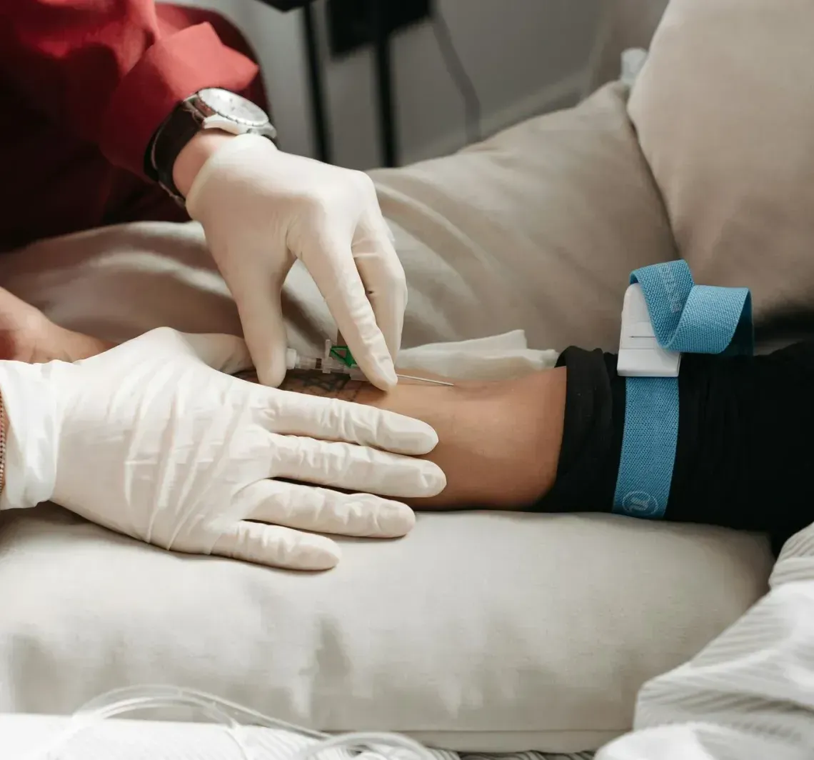 Hands giving a massage on a person's lower back under a white towel