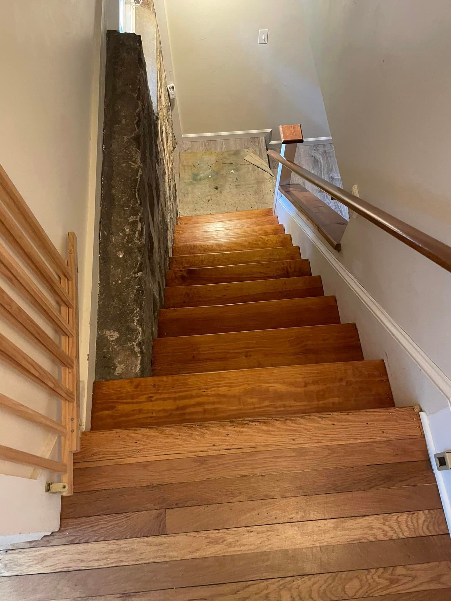 A set of wooden stairs leading up to the second floor of a house.