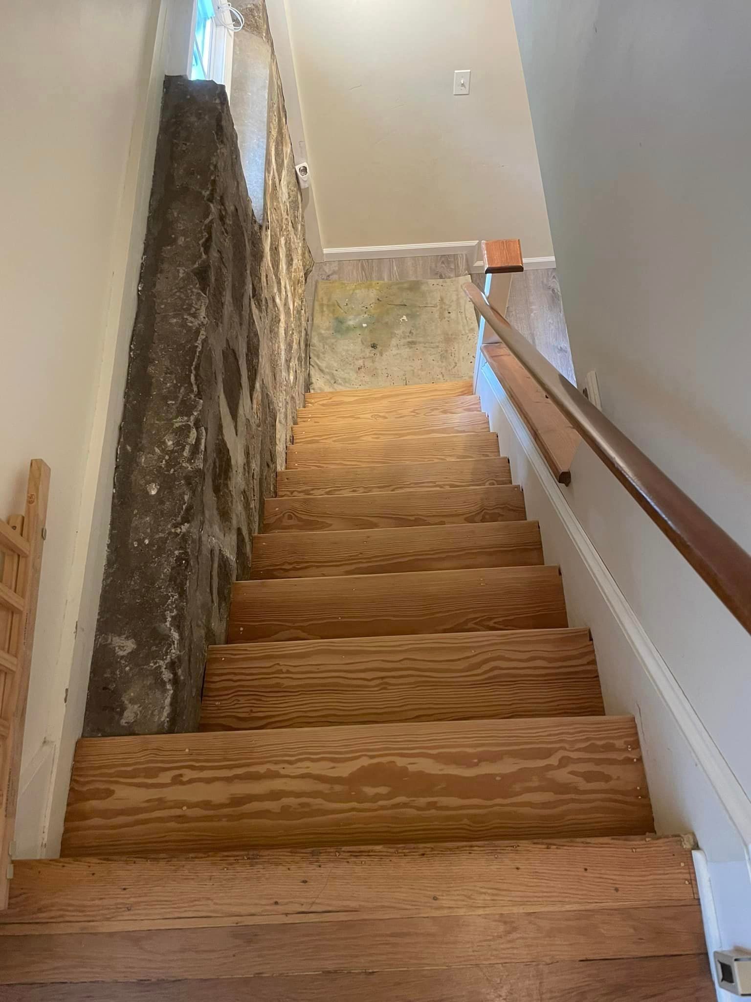 A set of wooden stairs leading up to the second floor of a house.