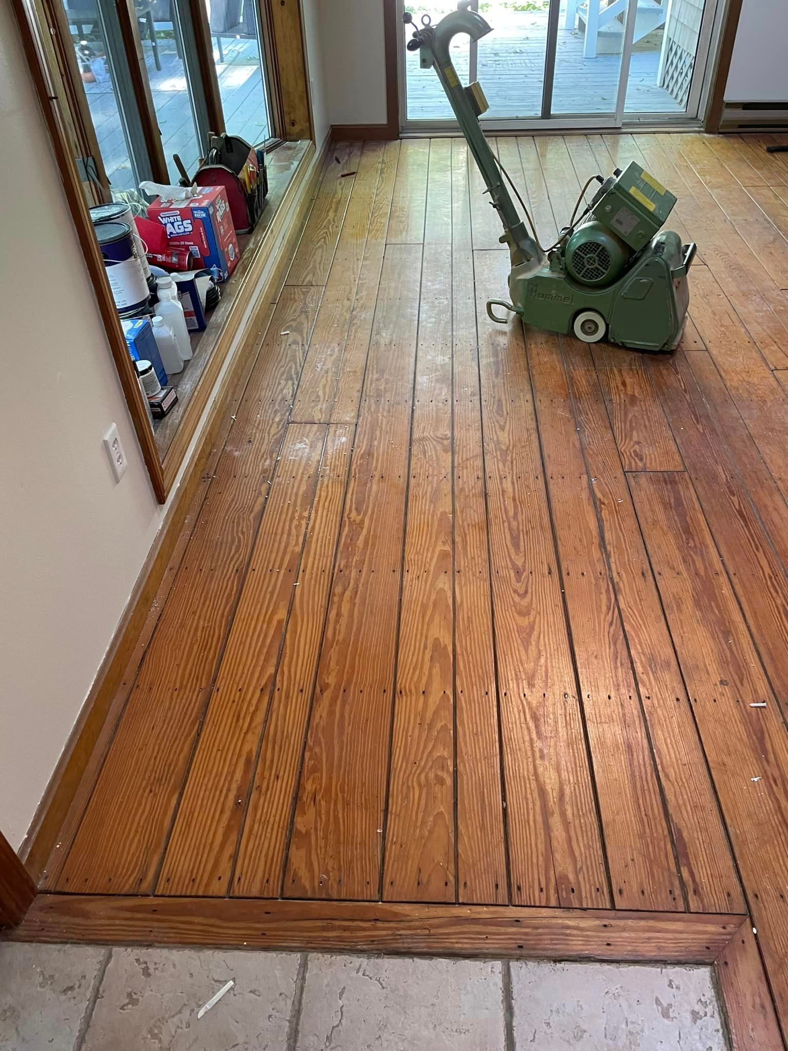 A machine is sitting on a wooden floor in a room.