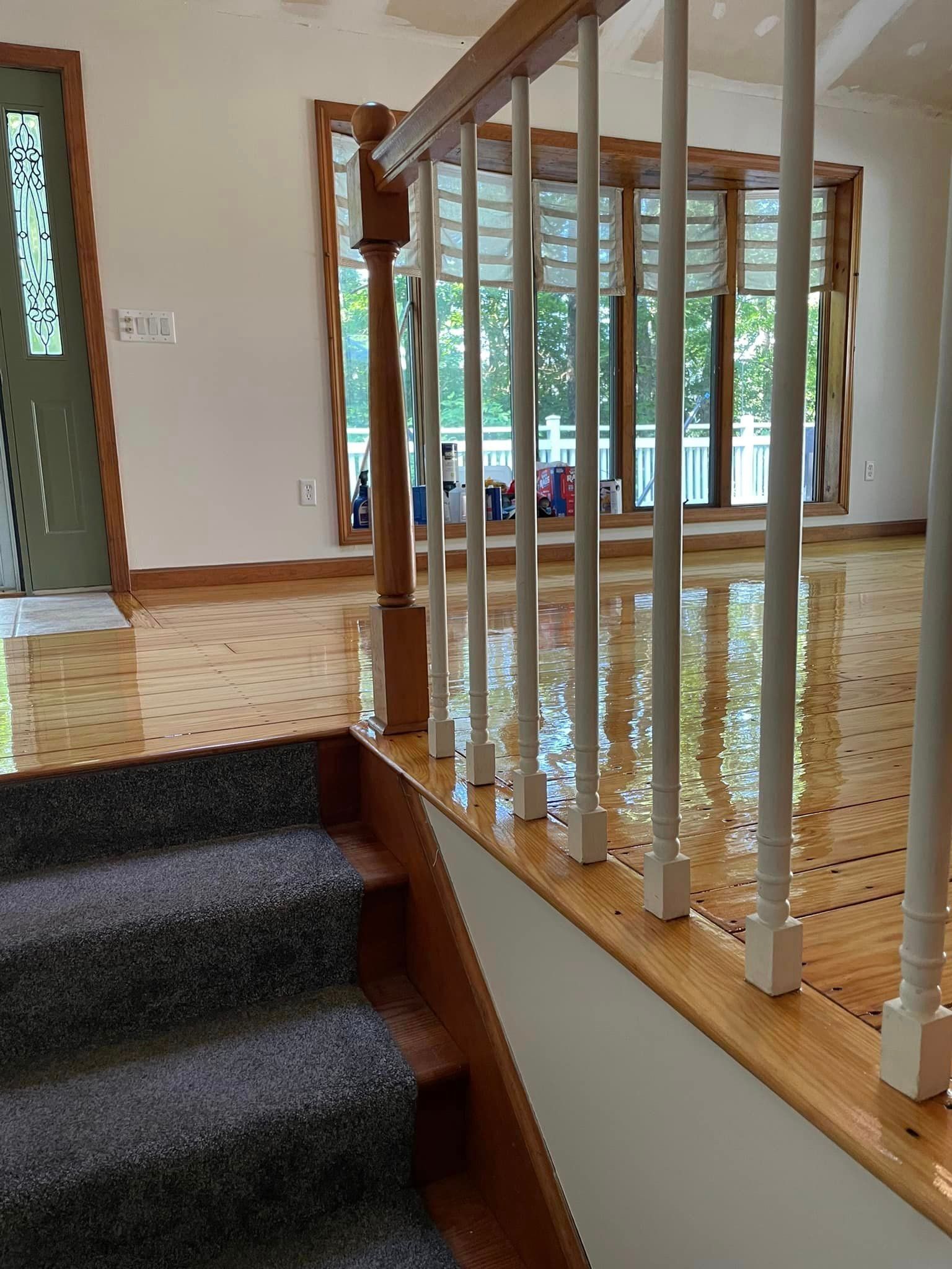 A staircase leading up to a living room with a wooden railing.