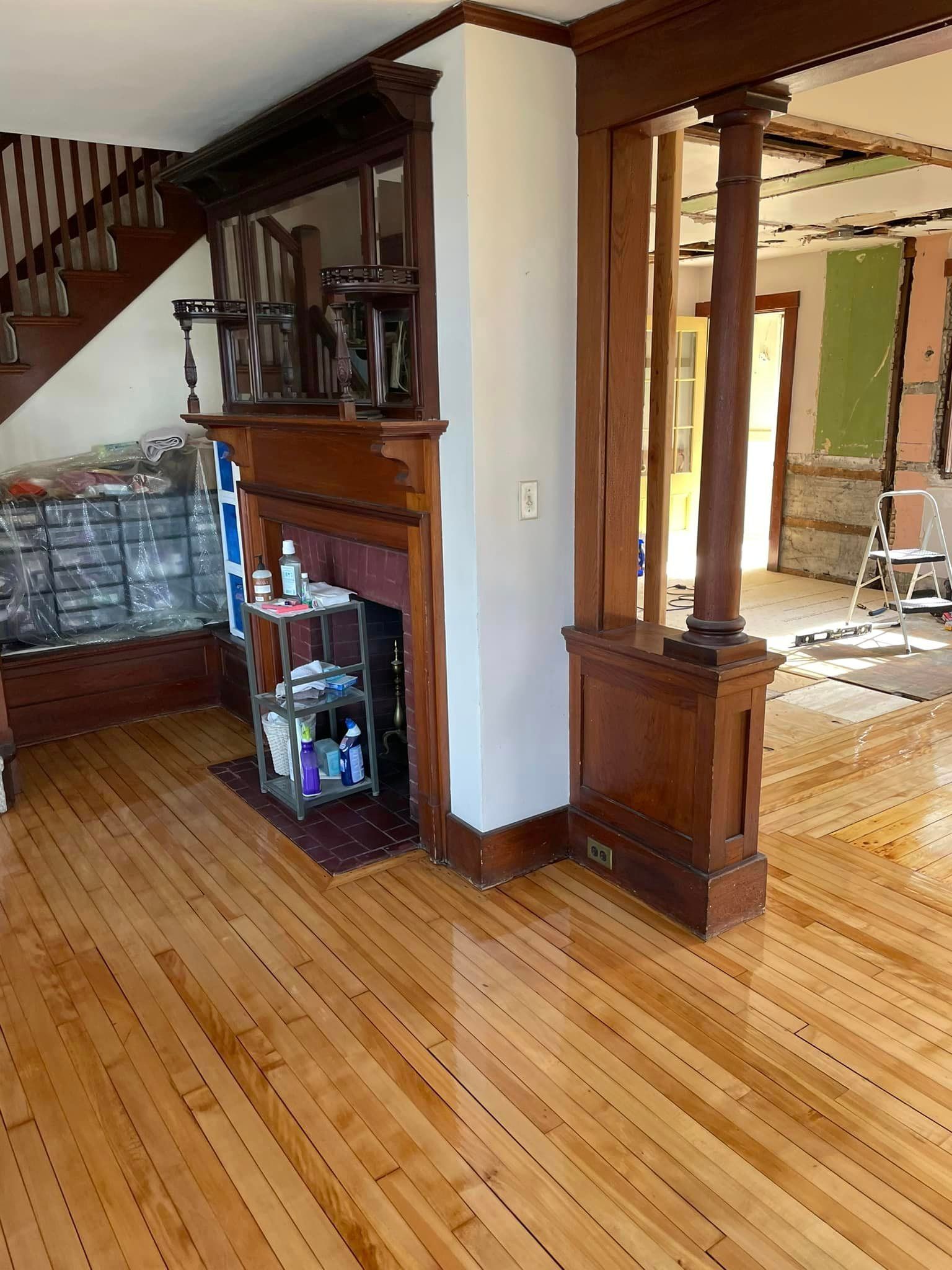 A living room with hardwood floors and a fireplace