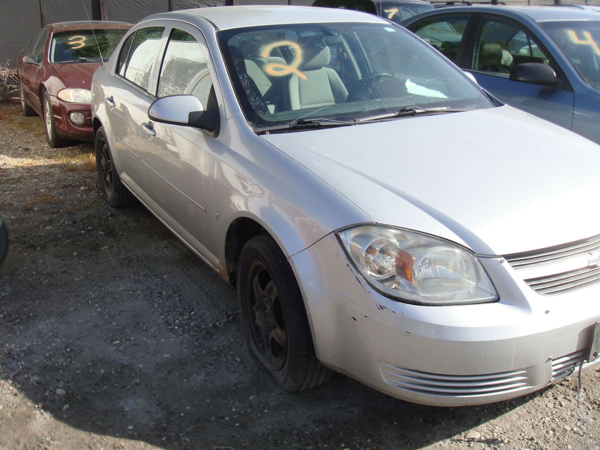 Silver sedan parked in a lot, viewed from the front-left side.