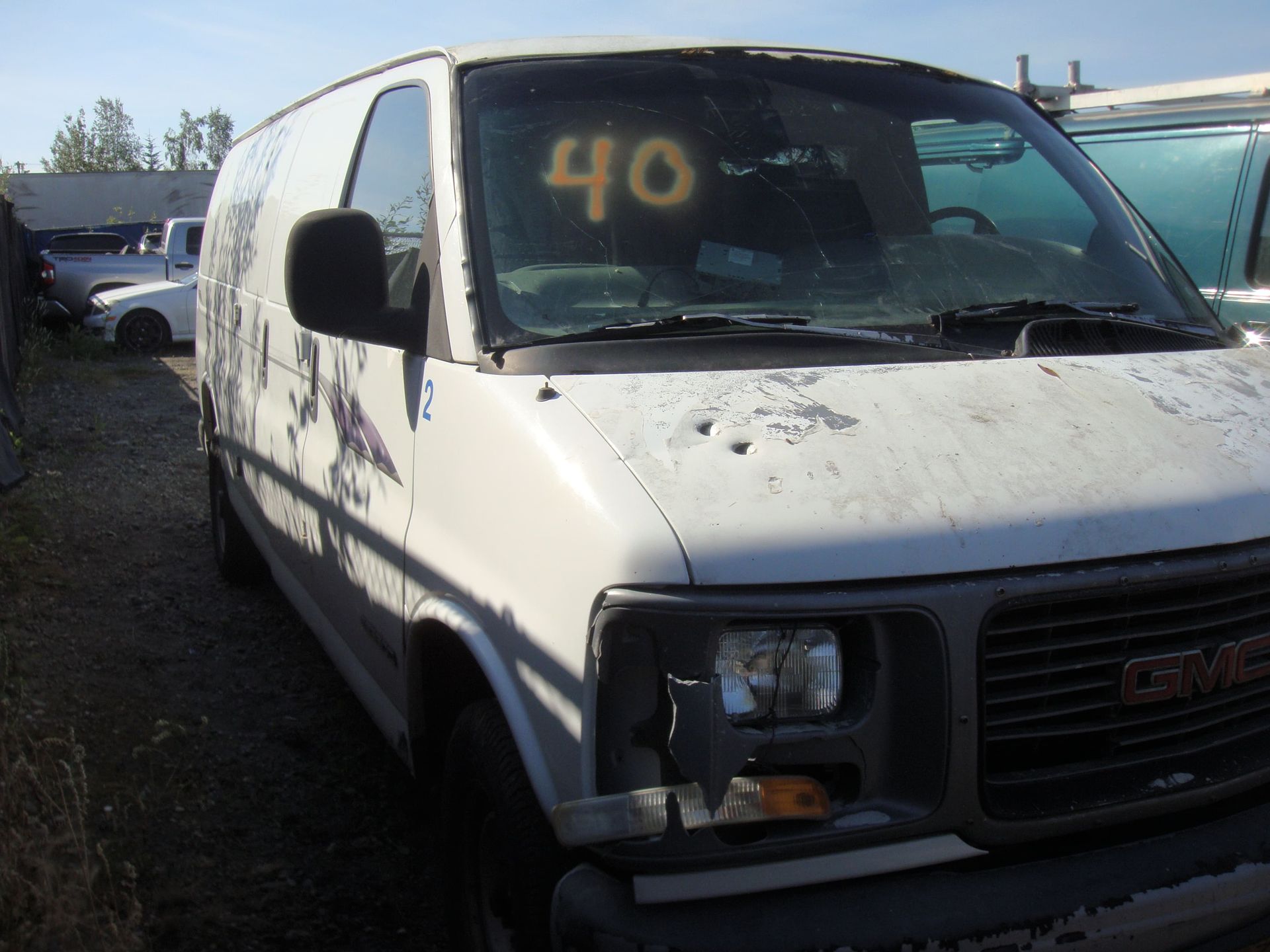 White cargo van parked in a lot, front view with a large “40” on the windshield