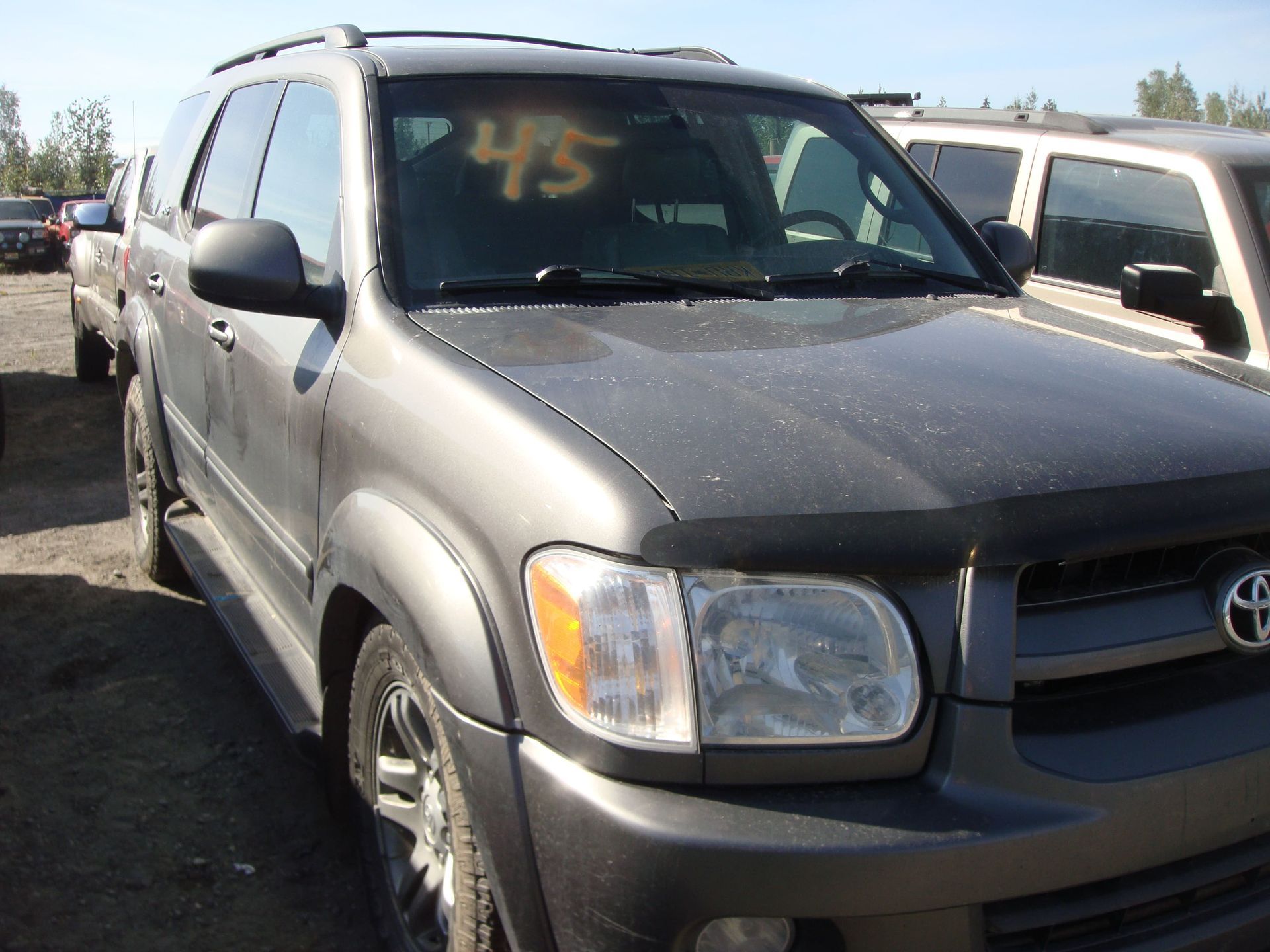 Gray Toyota SUV parked in a lot, with a yellow “45” written on the windshield.