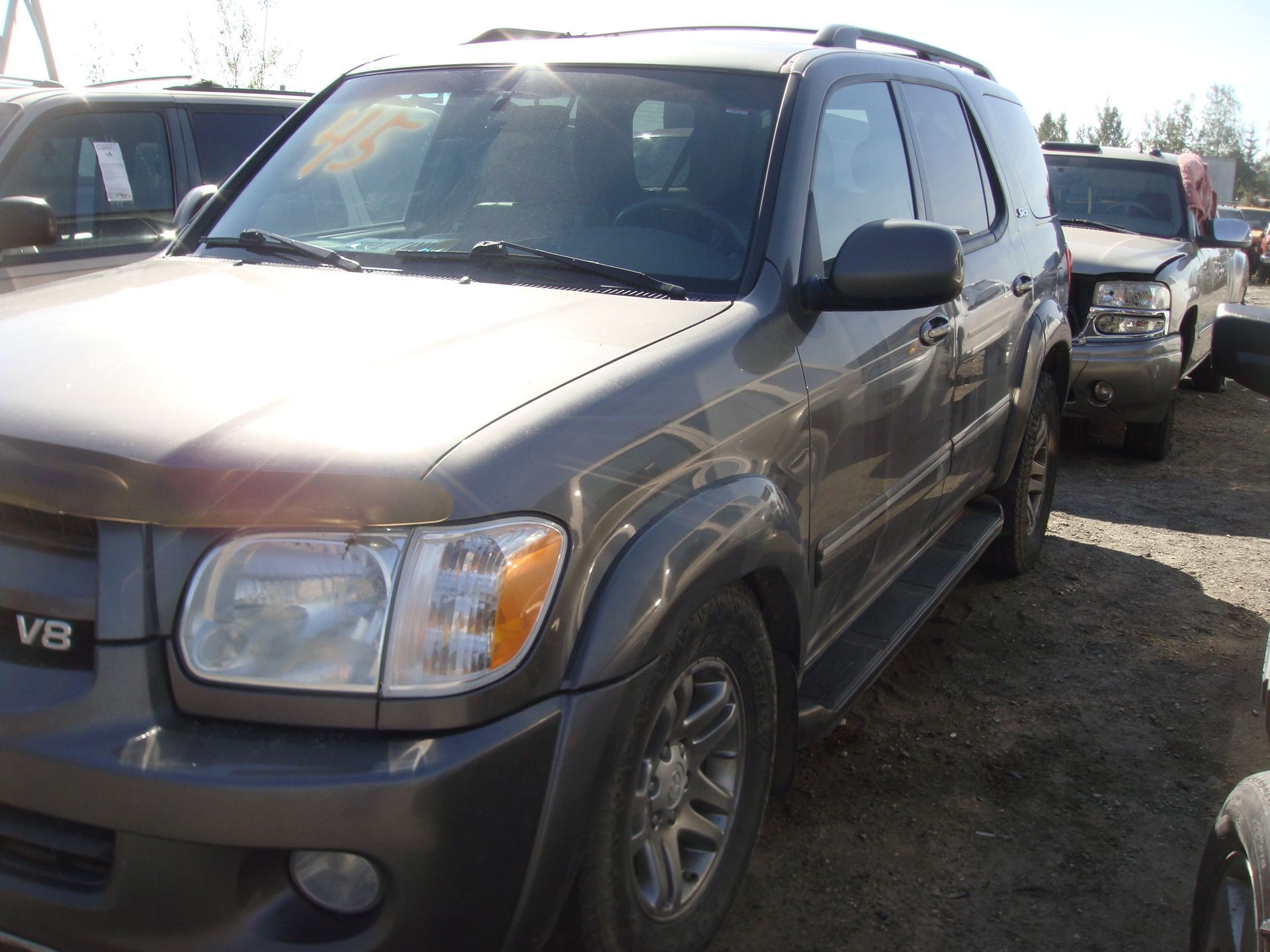 Dark gray SUV parked in a lot, seen from the front-left side.