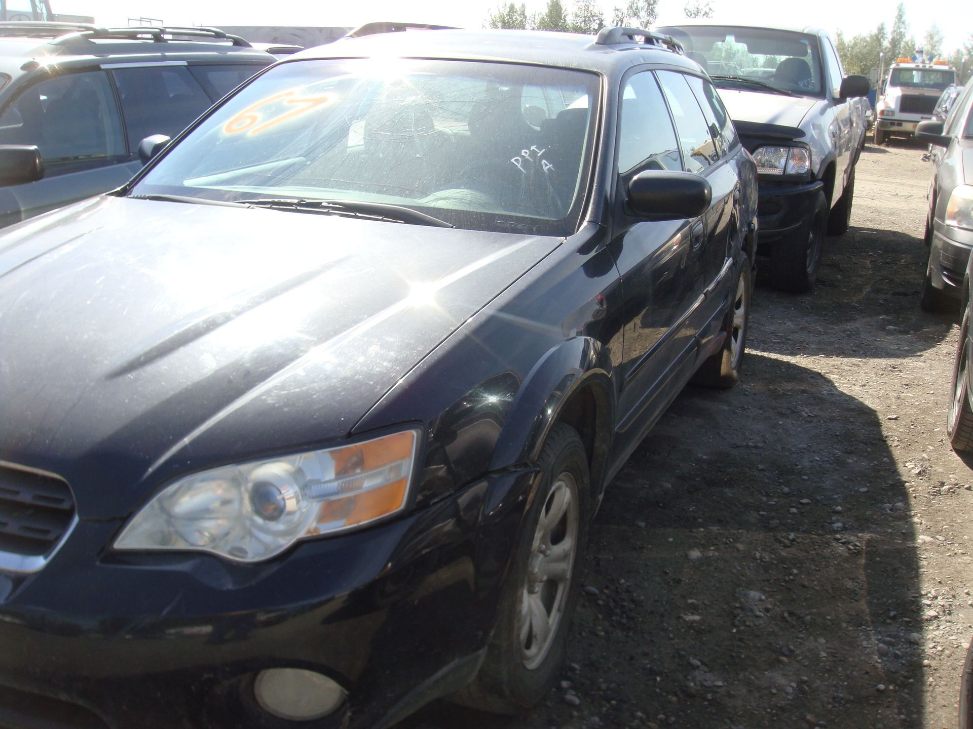 Black SUV parked in a crowded lot, front-left view