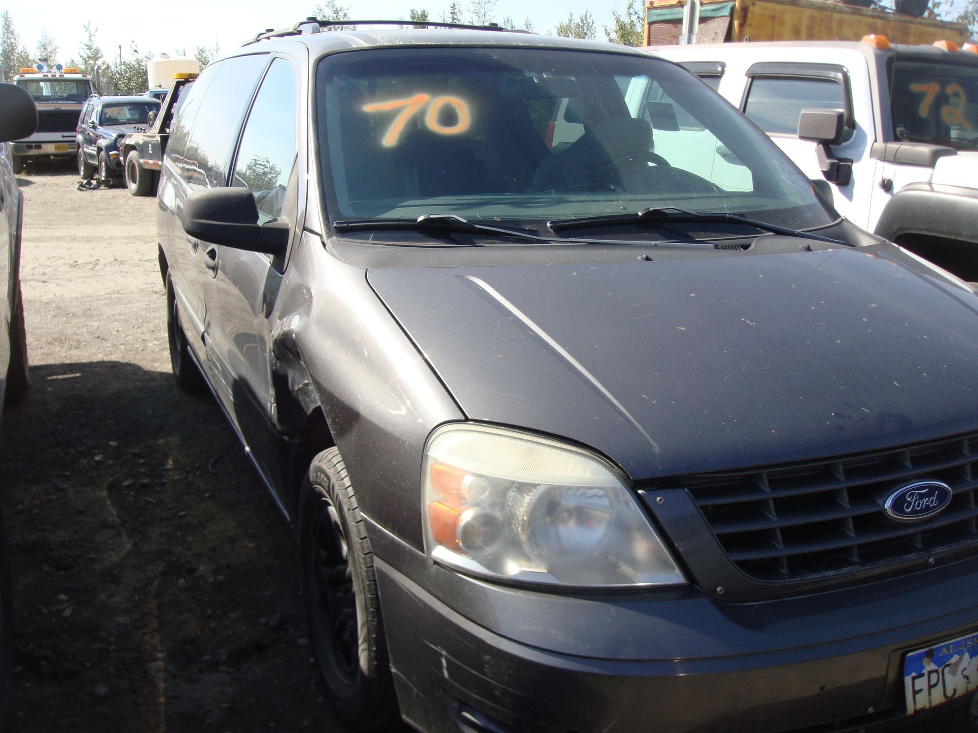 Gray Ford SUV parked in a lot with “70” marked on the windshield
