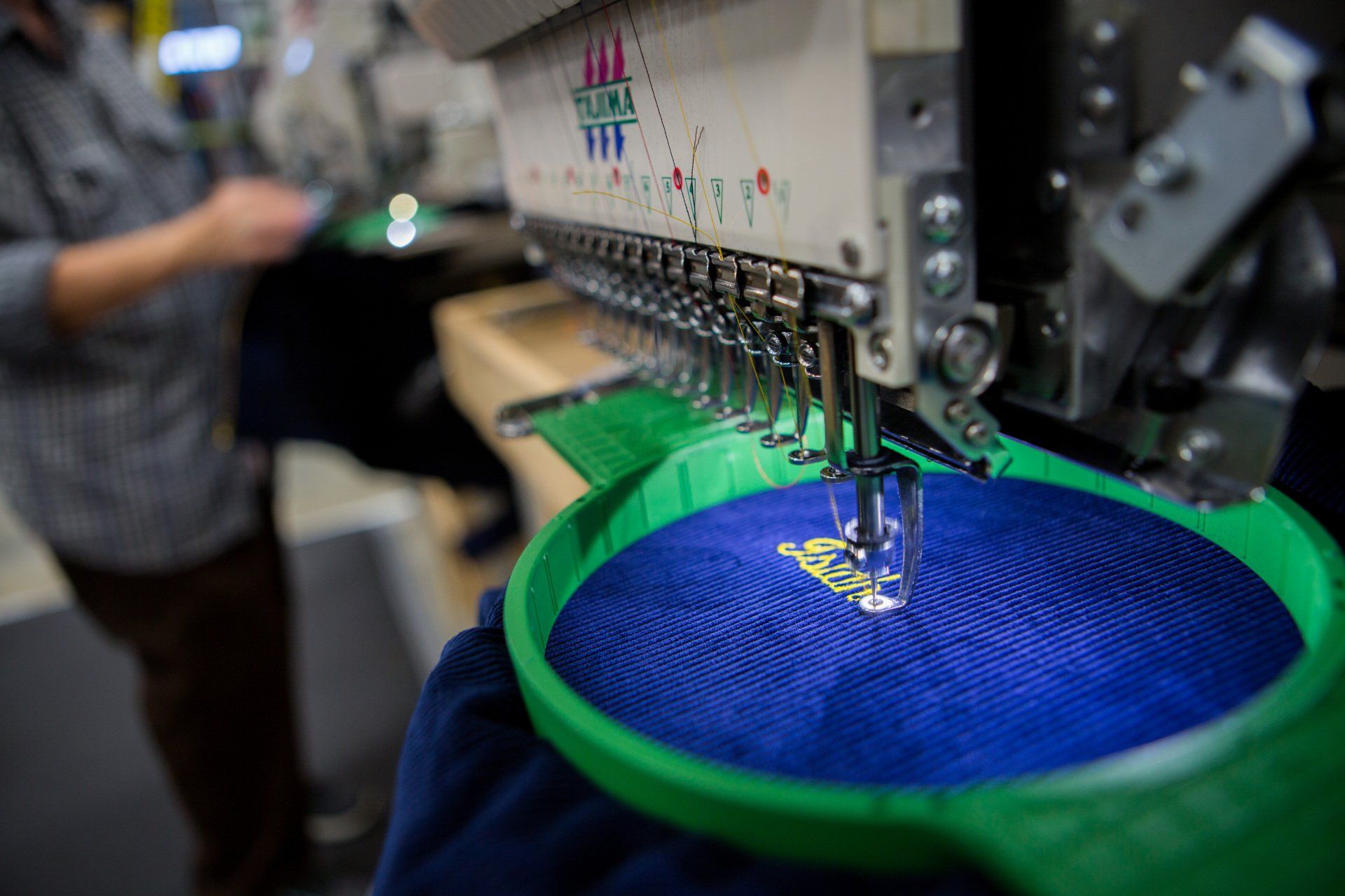 A custom name being sewed into a FFA jacket.
