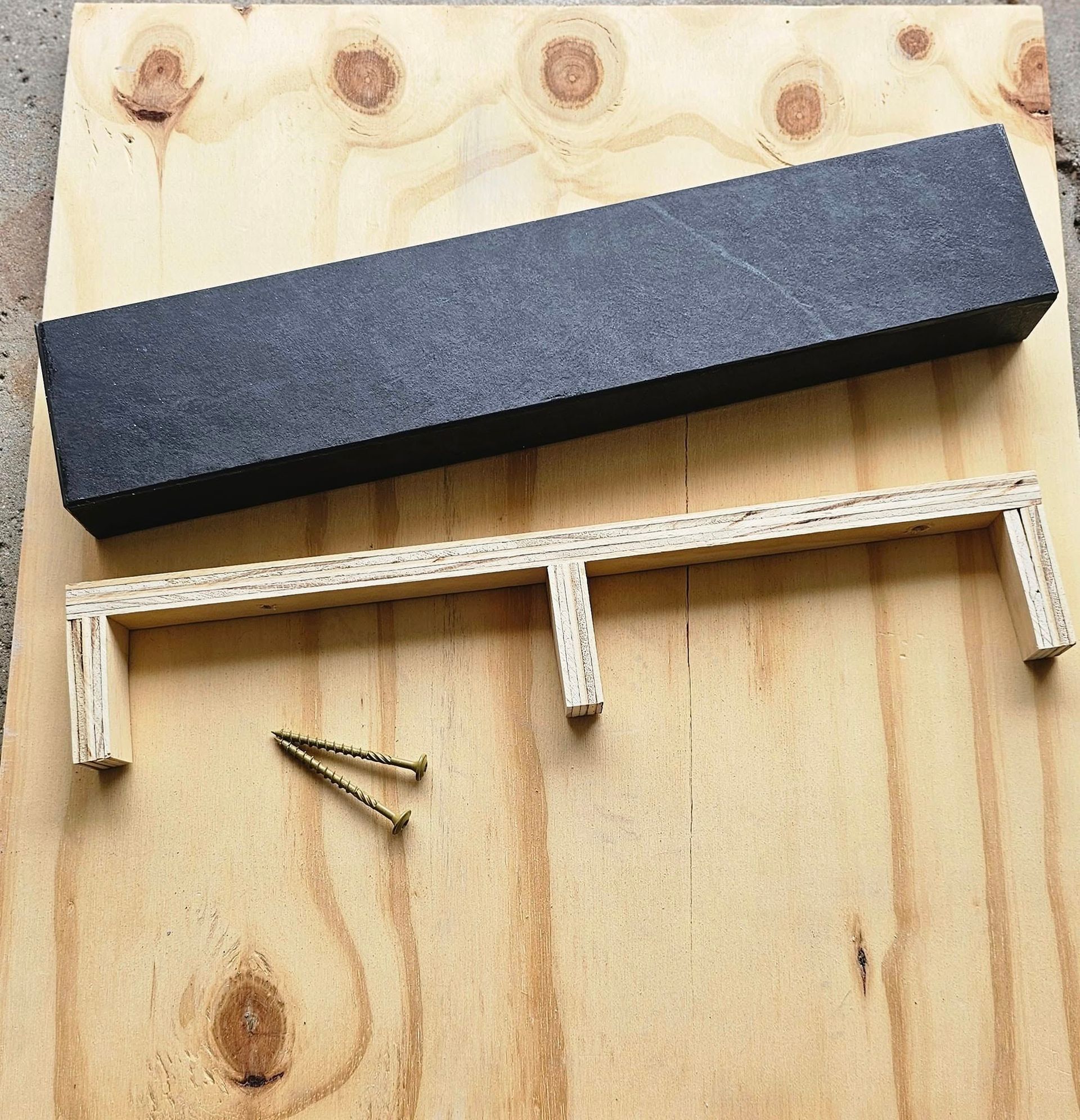 A piece of wood with two nails on it