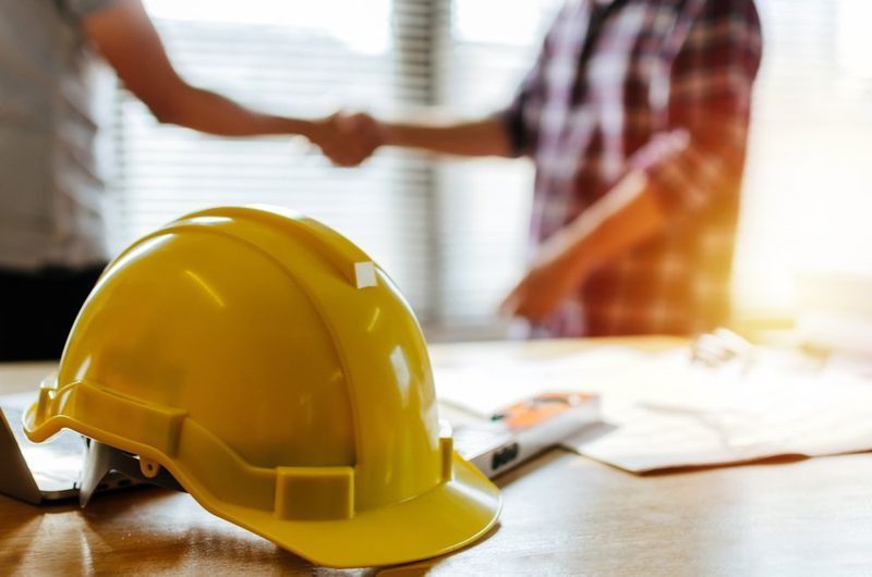 Yellow Hard Hat On A Table — Wendy's Safety Services in Moulden, NT