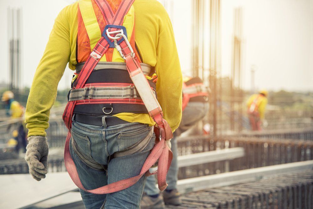 Construction Worker Wearing A Safety Harness On A Building Site — Wendy's Safety Services in Moulden, NT