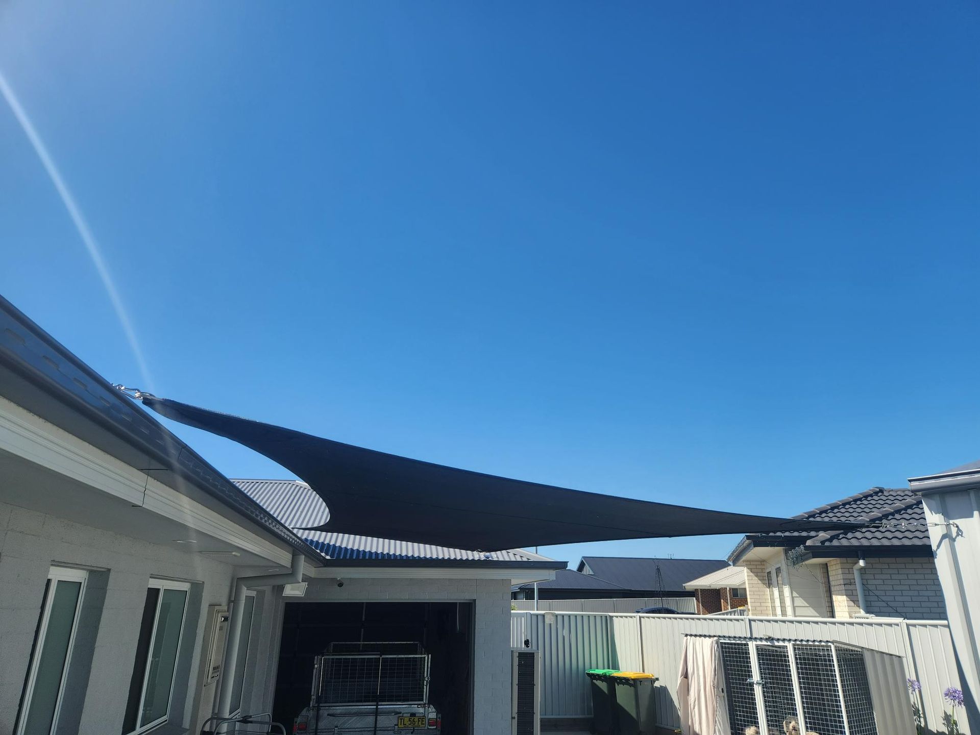 A Black Shade Sail Is Covering the Roof of A House — New England Shade Sails in Tamworth, NSW