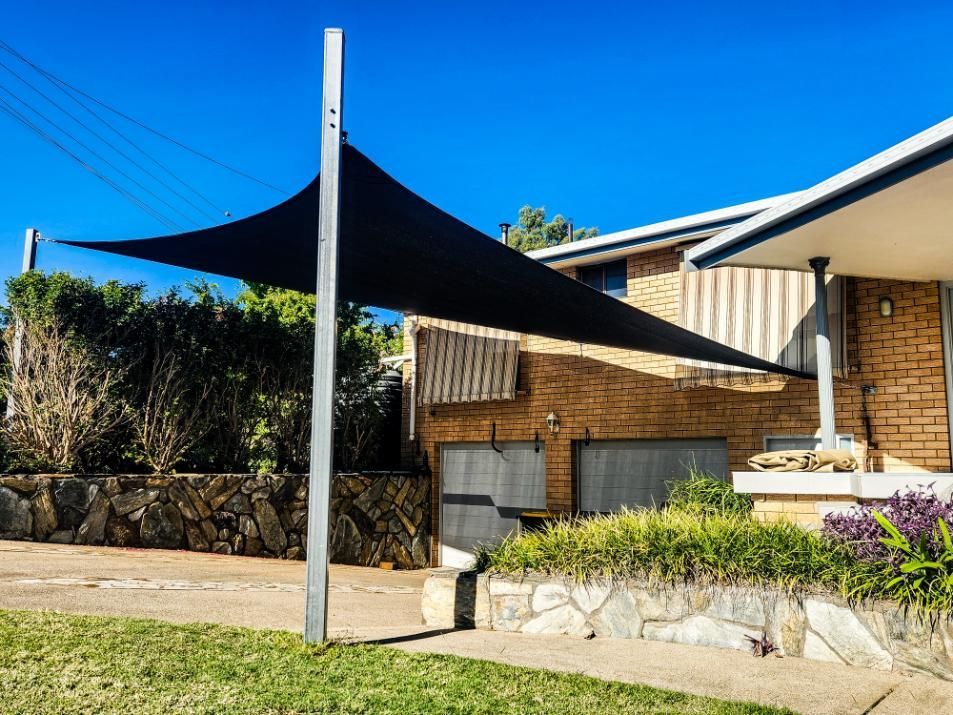 A Black Shade Sail Is Sitting in Front of A Brick House — New England Shade Sails in Armidale, NSW