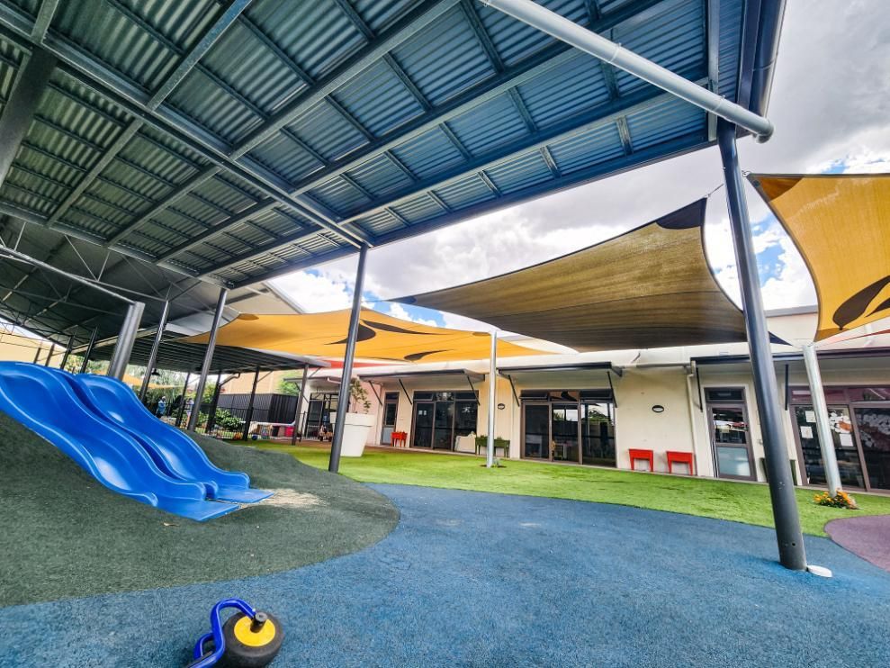 A Playground with A Slide and A Wheelbarrow Under a Canopy — New England Shade Sails in Armidale, NSW