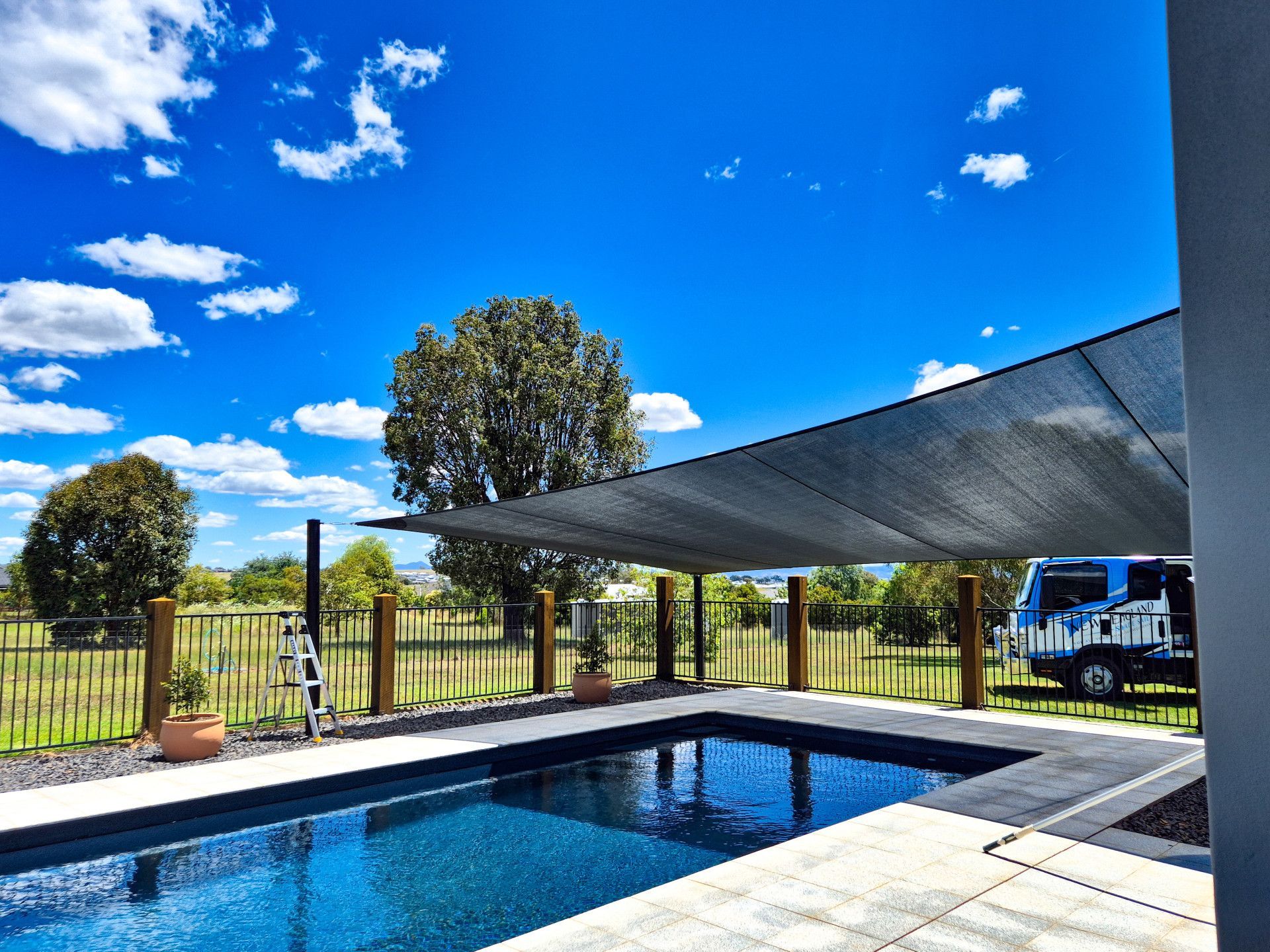 A Swimming Pool with A Black Shade Sail — New England Shade Sails in North Tamworth, NSW