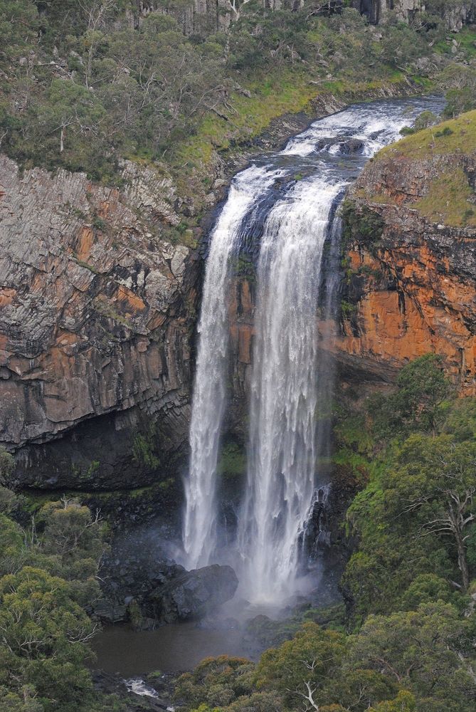 A Waterfall Is Surrounded by Trees and Rocks in The Middle of A Forest — New England Shade Sails in Armidale, NSW