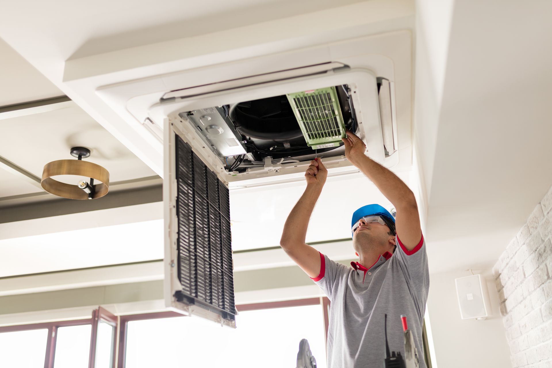 technicians repairing a ducted air conditioning system