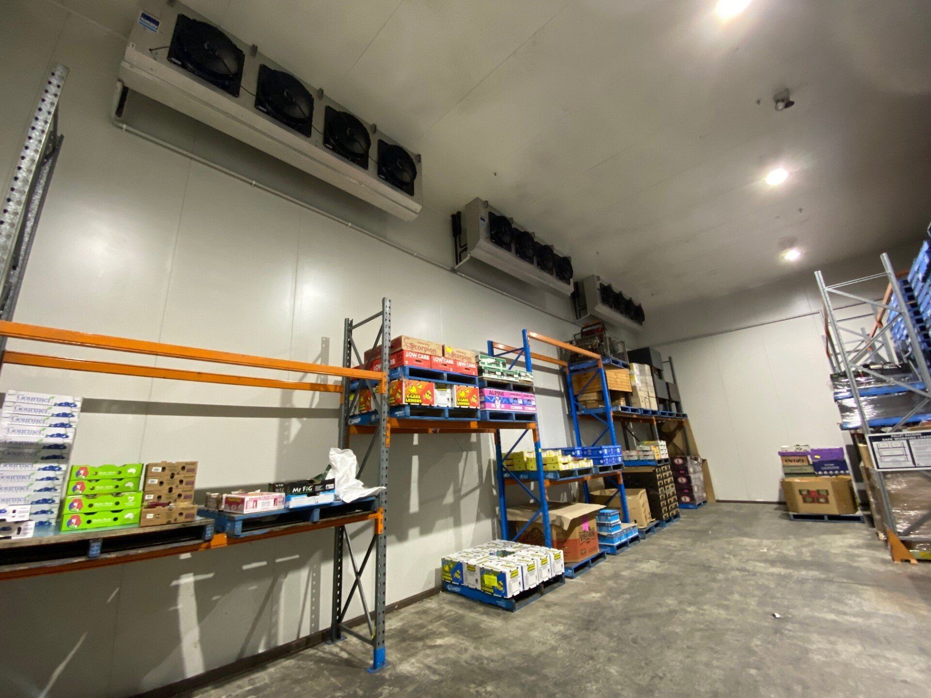 commercial cool room with storage shelves lining the walls