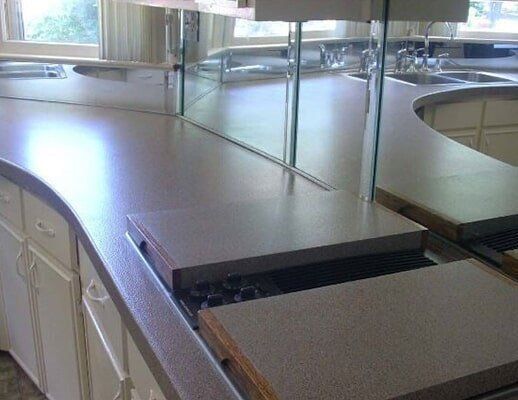 A kitchen counter with a lot of mirrors on it.
