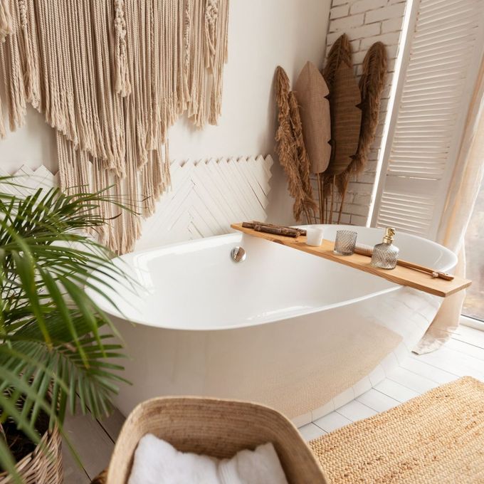 A bathtub with a wooden tray on it in a bathroom