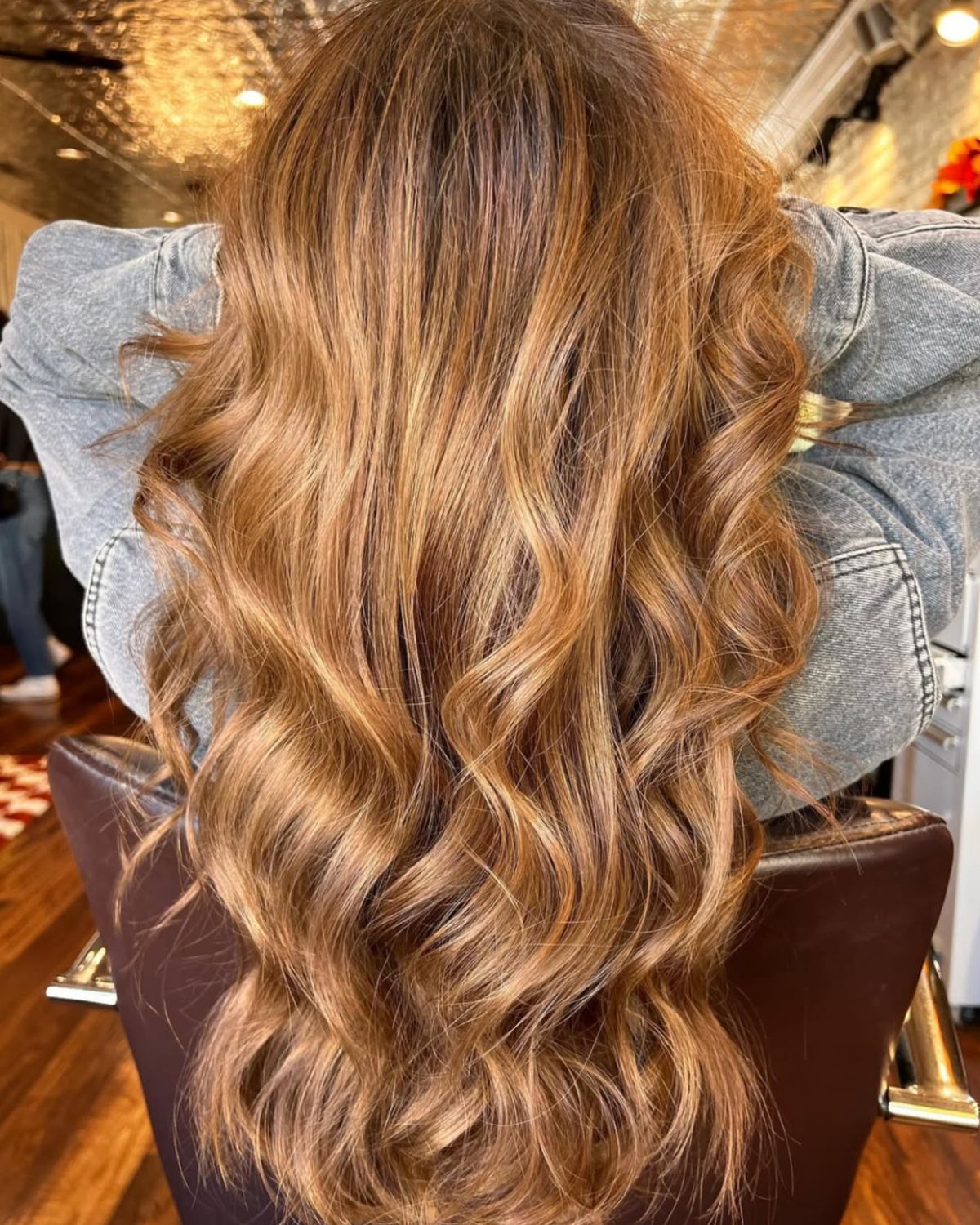 Long, wavy auburn hair with subtle highlights.