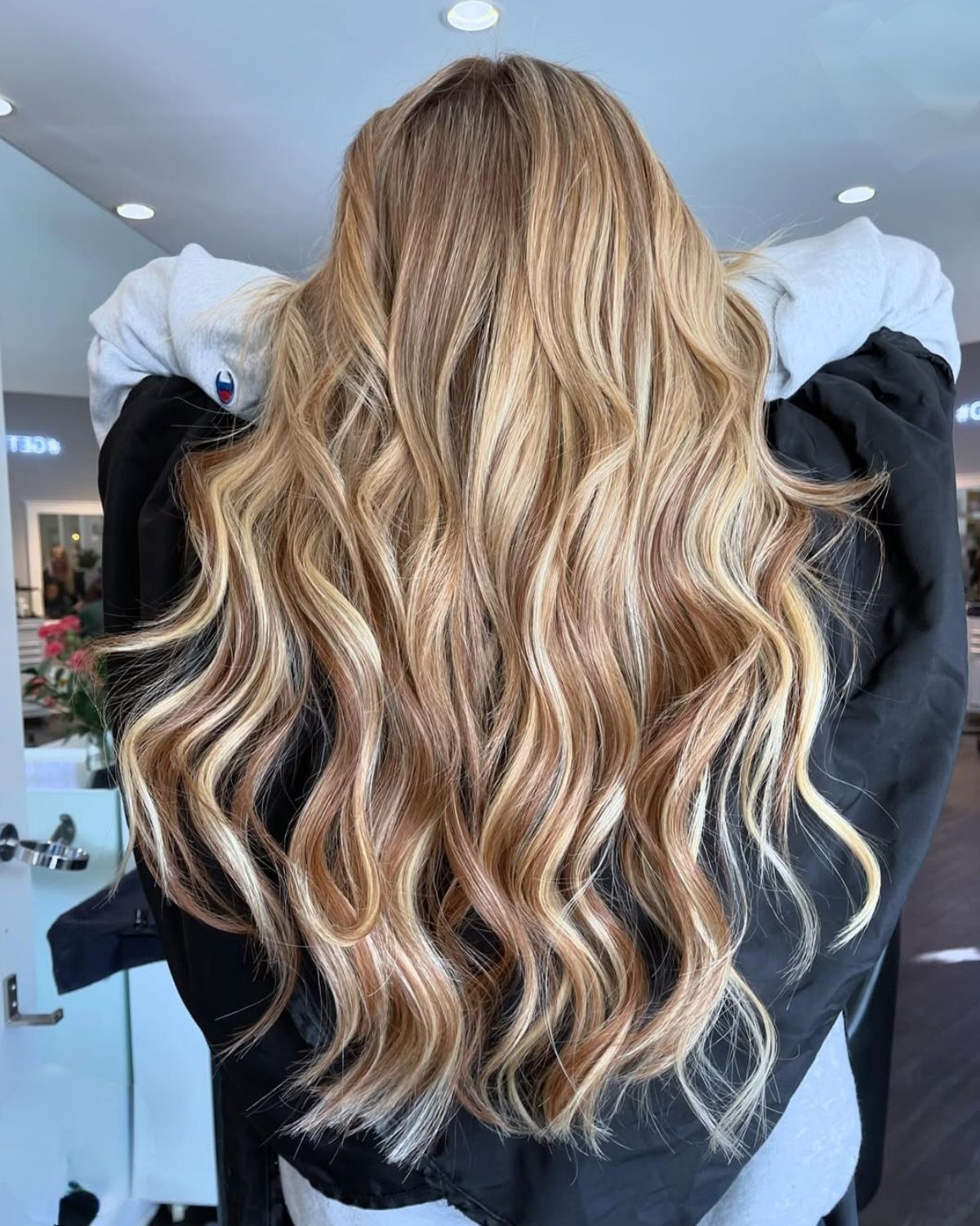 Long, wavy blonde and light brown highlighted hair.