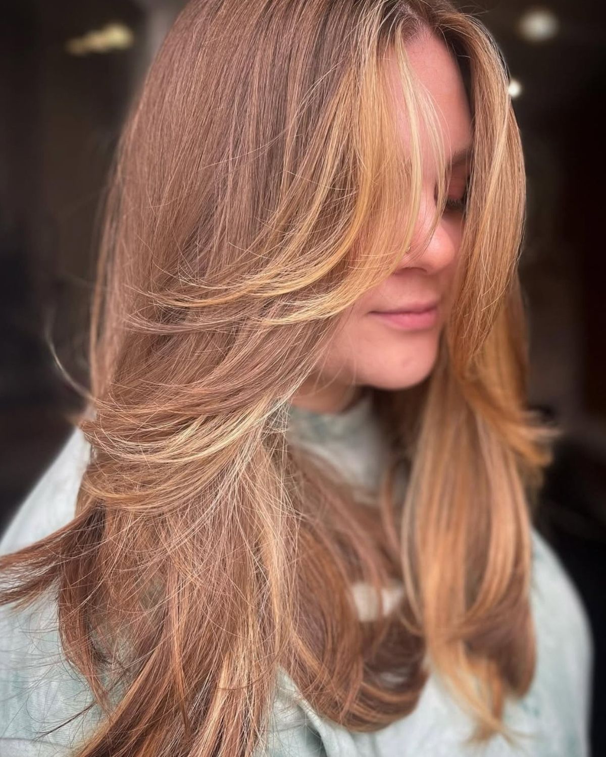Woman with long layered blonde and brown hair.