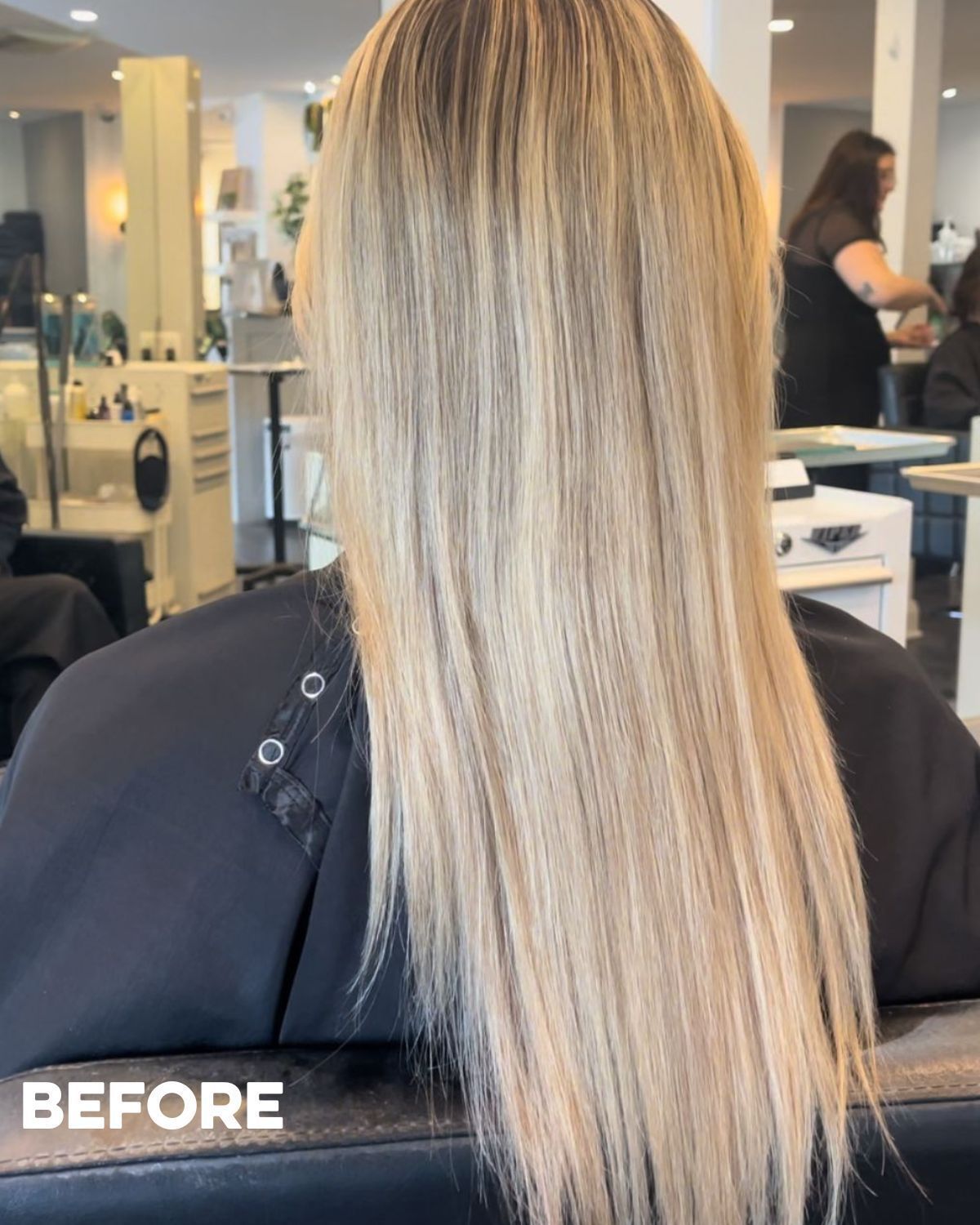 Woman with long, blonde hair at a salon before a hair service.