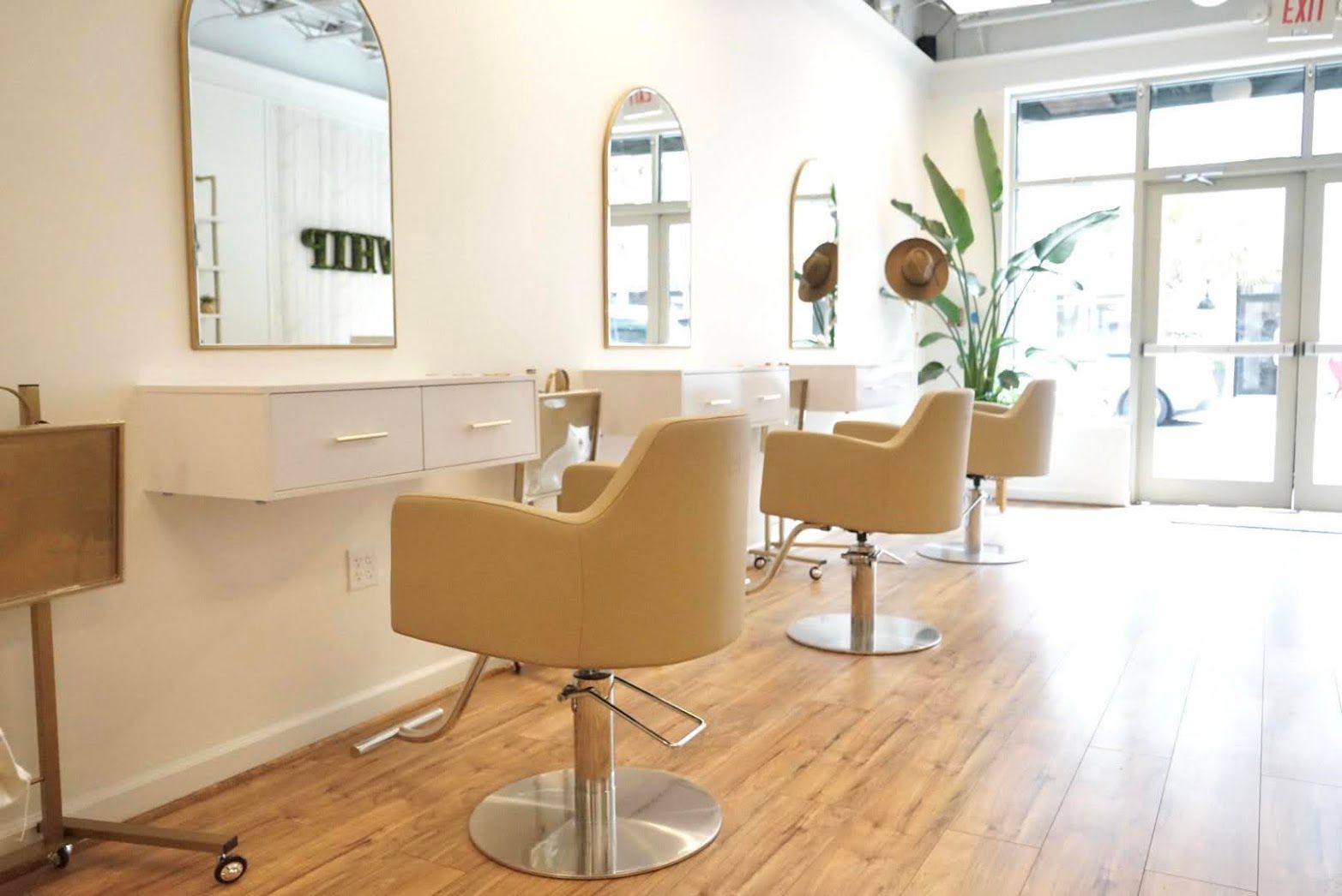 A salon with a lot of chairs and mirrors