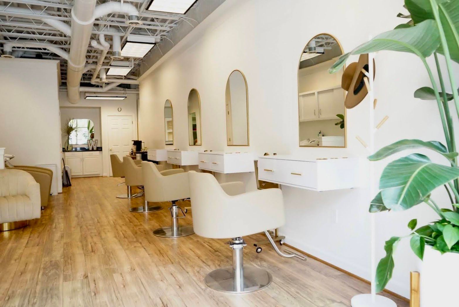 A hair salon with a lot of chairs and mirrors.